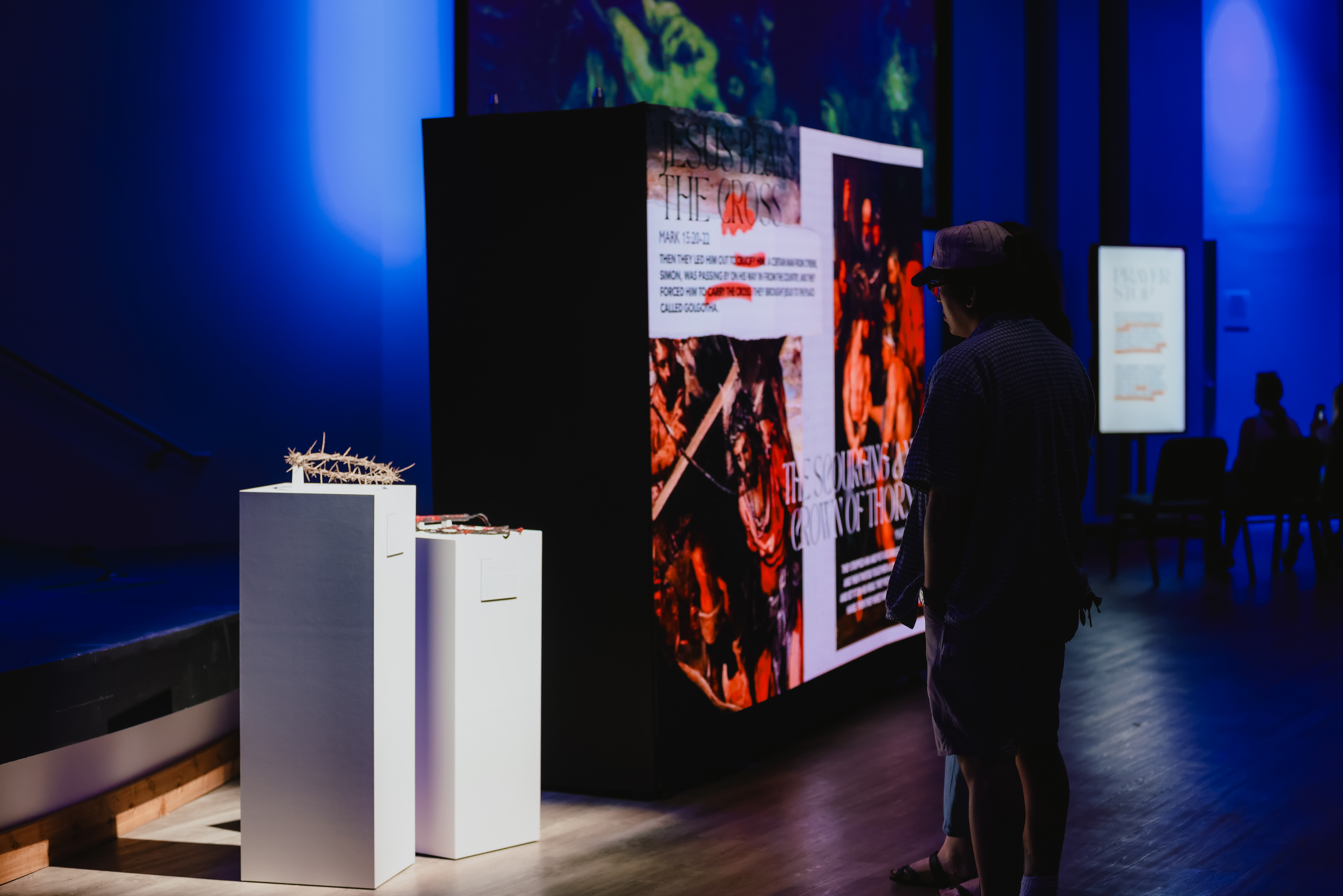 Immersive Good Friday Experience with large red-lit display panels.